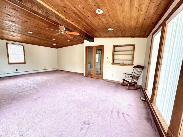 unfurnished room featuring a healthy amount of sunlight, a baseboard radiator, and lofted ceiling with beams