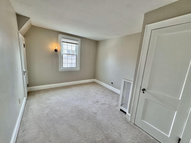 unfurnished room with light colored carpet