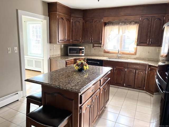 kitchen featuring a center island, tasteful backsplash, and sink