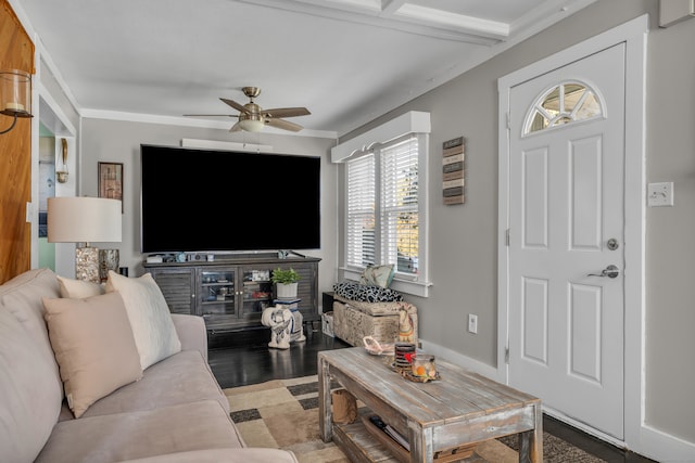 living room with crown molding, beamed ceiling, light wood-type flooring, and ceiling fan