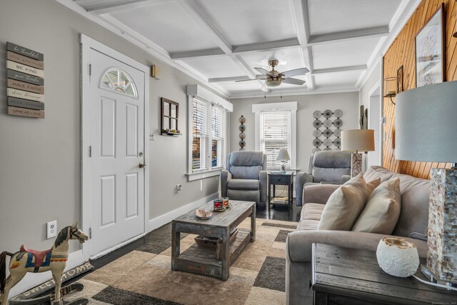 living room featuring hardwood / wood-style floors, ceiling fan, coffered ceiling, beamed ceiling, and ornamental molding