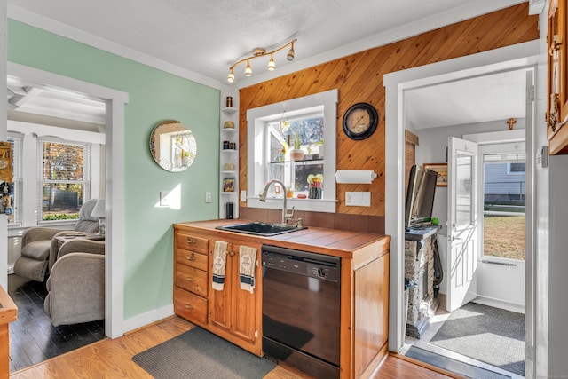 kitchen with sink, tile countertops, dishwasher, and plenty of natural light