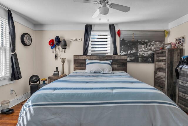 bedroom featuring hardwood / wood-style flooring and ceiling fan