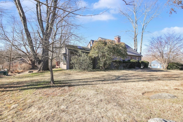 view of side of property with a yard