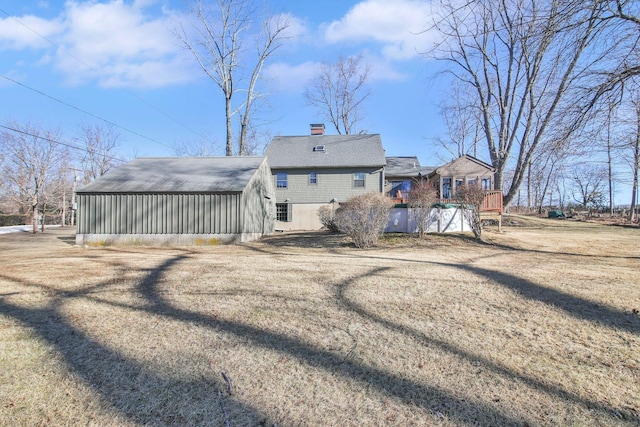 back of property featuring a yard