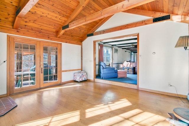 empty room with light wood-type flooring, french doors, wooden ceiling, and lofted ceiling with beams