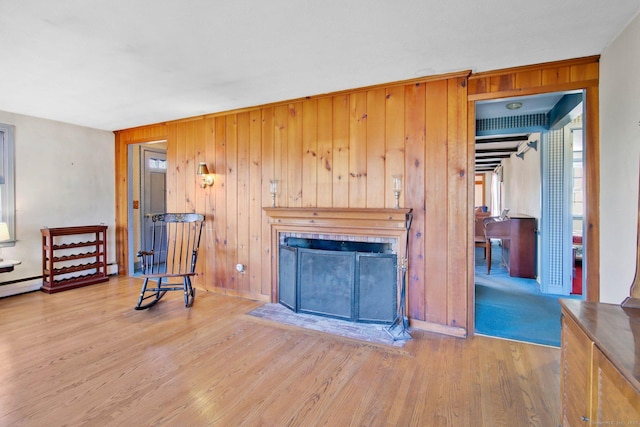 living room with wood walls and light wood-type flooring