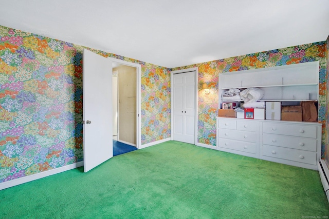 unfurnished bedroom with carpet floors and a baseboard heating unit