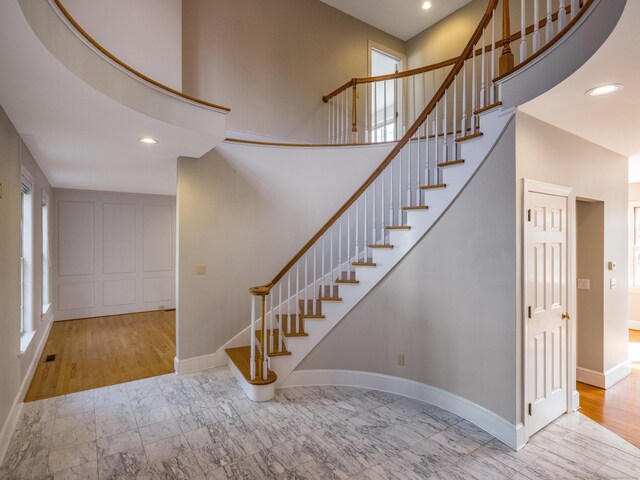 13 Longview Ter Unit 13, Madison, CT 06443 - stairway with healthy amount of natural light, baseboards, a high ceiling, recessed lighting, and marble look tile flooring