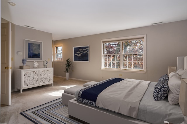 bedroom featuring light colored carpet