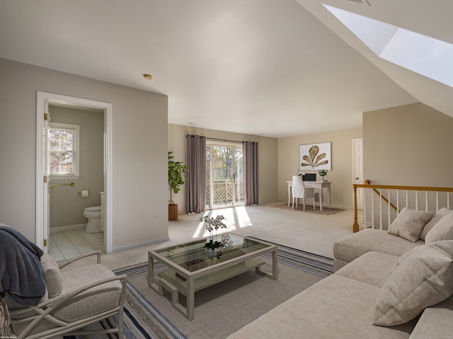 living room featuring a healthy amount of sunlight, a skylight, and carpet floors