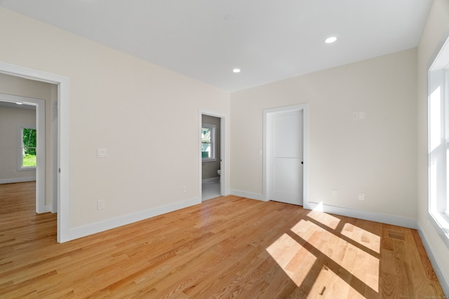 unfurnished room with light wood-type flooring and plenty of natural light