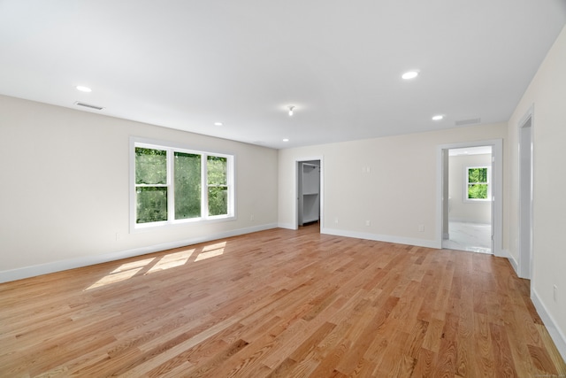 empty room featuring light wood-type flooring and a wealth of natural light