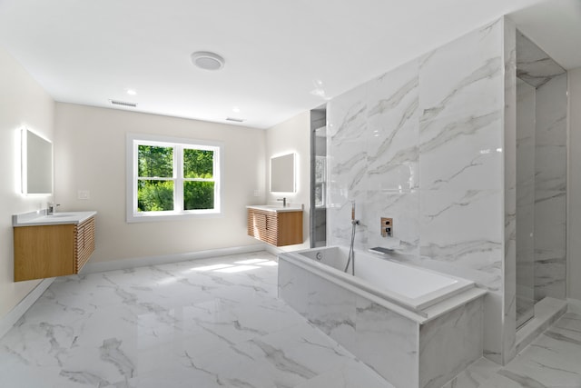 bathroom featuring vanity and independent shower and bath