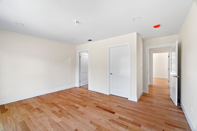 unfurnished bedroom with light wood-type flooring