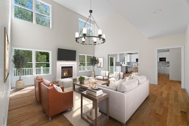 living room with a notable chandelier, hardwood / wood-style floors, high vaulted ceiling, and a wealth of natural light