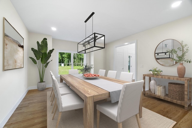 dining area with dark hardwood / wood-style flooring and an inviting chandelier