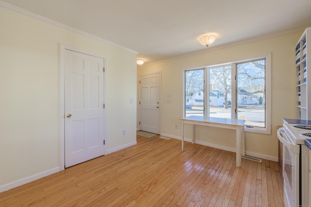 interior space with ornamental molding and light hardwood / wood-style floors