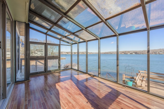 unfurnished sunroom with plenty of natural light and a water view