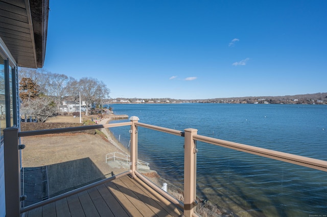 dock area with a balcony and a water view