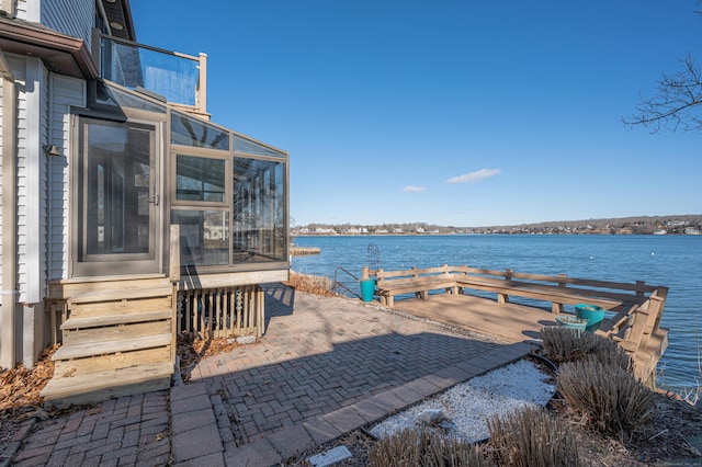 exterior space featuring a dock and a water view