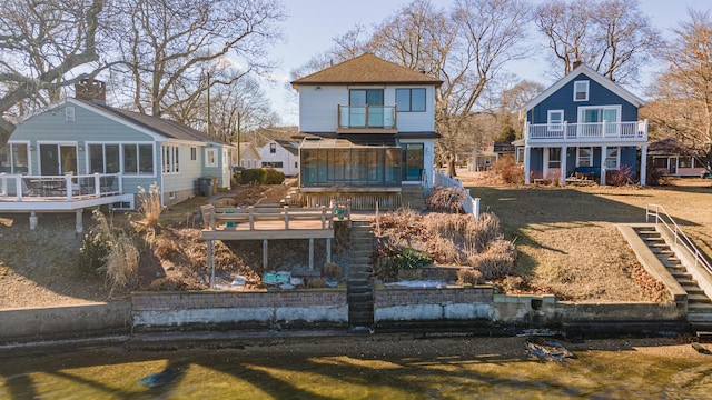 rear view of property featuring a balcony