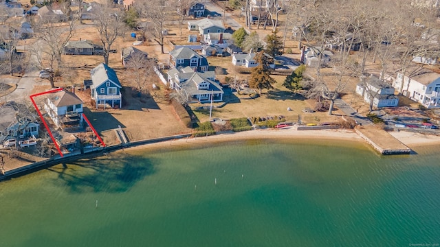 drone / aerial view with a water view and a beach view