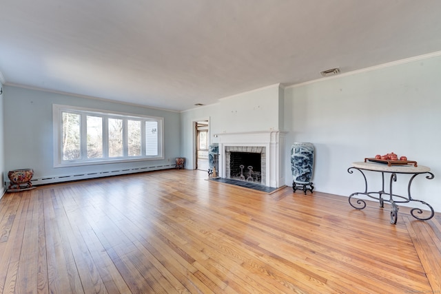 unfurnished living room featuring a fireplace, visible vents, baseboard heating, wood-type flooring, and crown molding