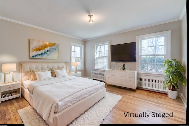 bedroom featuring radiator, light wood finished floors, and crown molding