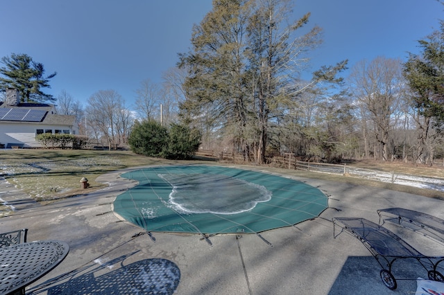 view of swimming pool with a patio area