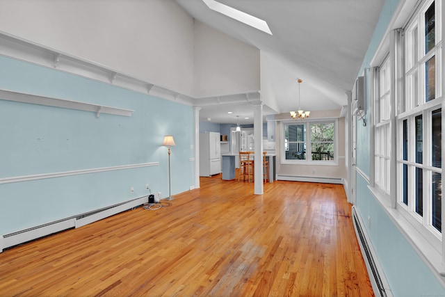 unfurnished living room with a baseboard radiator, a chandelier, high vaulted ceiling, and light hardwood / wood-style floors