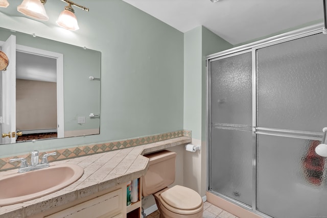 bathroom with vanity, tile patterned flooring, toilet, and an enclosed shower