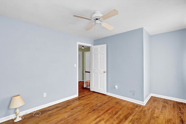 spare room with ceiling fan and hardwood / wood-style flooring