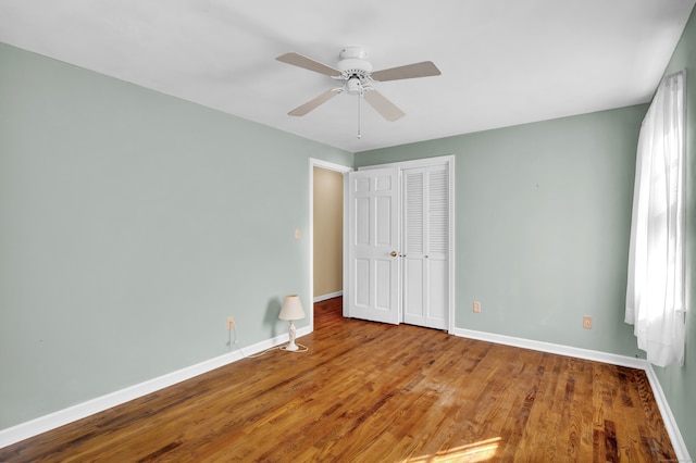 unfurnished bedroom with a closet, ceiling fan, and hardwood / wood-style floors