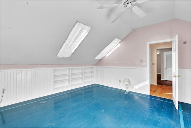 view of swimming pool with a skylight and ceiling fan