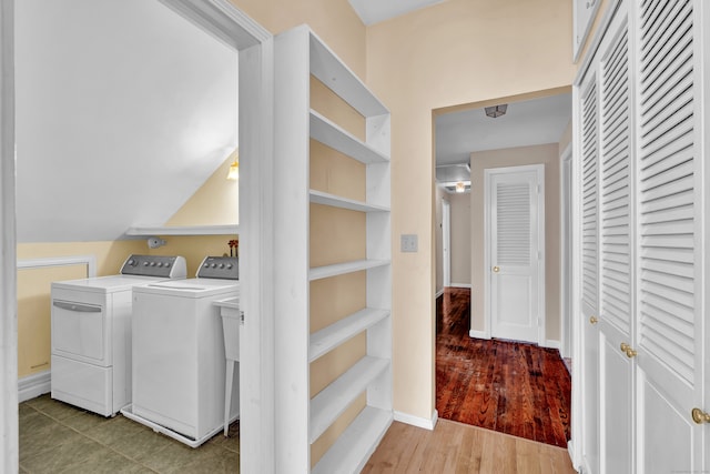 laundry room with hardwood / wood-style flooring and washing machine and dryer