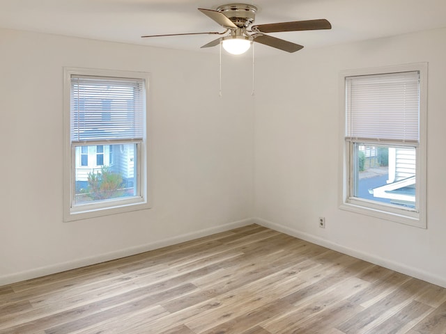 unfurnished room with light hardwood / wood-style flooring, a healthy amount of sunlight, and ceiling fan