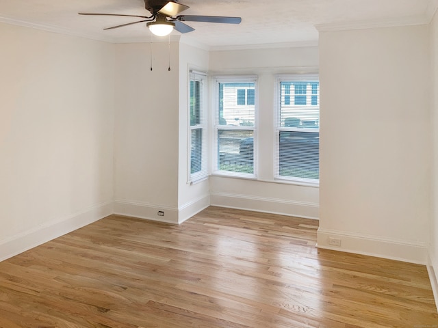 spare room featuring crown molding, light wood-type flooring, and ceiling fan