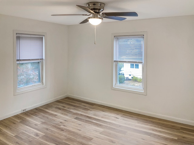 spare room with light hardwood / wood-style floors and ceiling fan