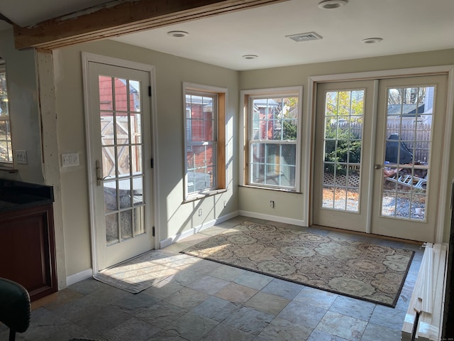 entryway with beam ceiling and french doors