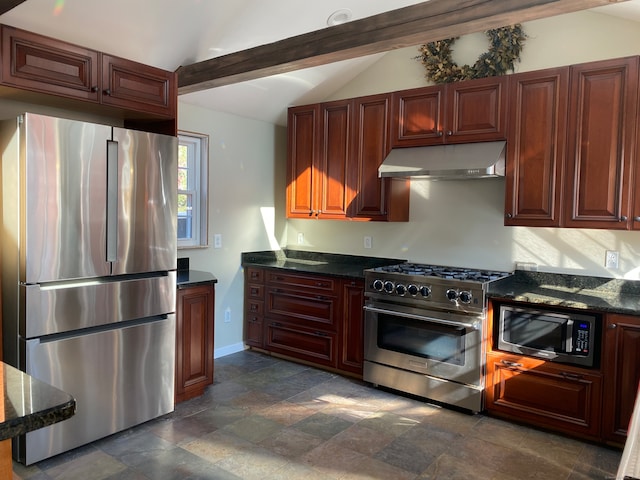 kitchen featuring appliances with stainless steel finishes, vaulted ceiling with beams, and dark stone counters