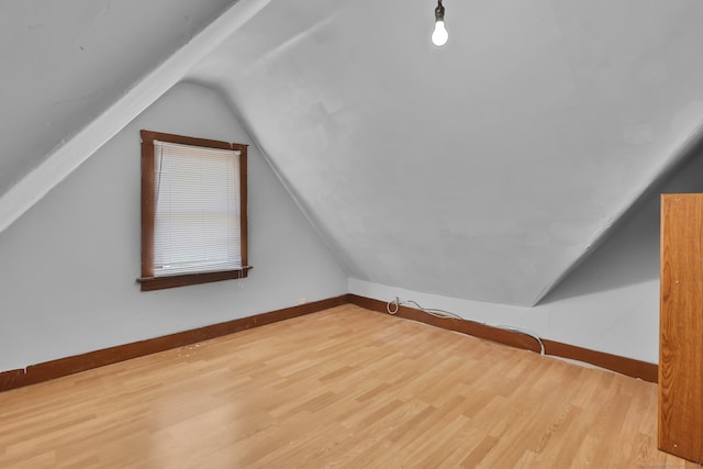 bonus room featuring light hardwood / wood-style floors and lofted ceiling