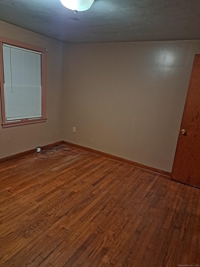 unfurnished room featuring hardwood / wood-style flooring