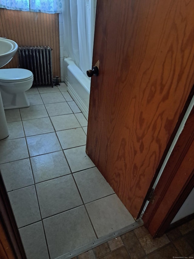 full bathroom with tile patterned floors, sink, toilet, shower / bathtub combination with curtain, and radiator heating unit