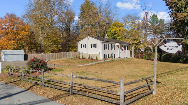 view of front of property with a shed and a front yard