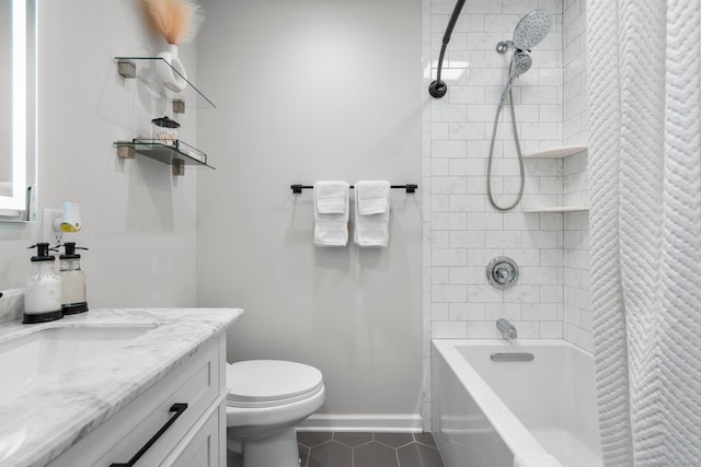 full bathroom featuring vanity, tiled shower / bath combo, toilet, and tile patterned flooring