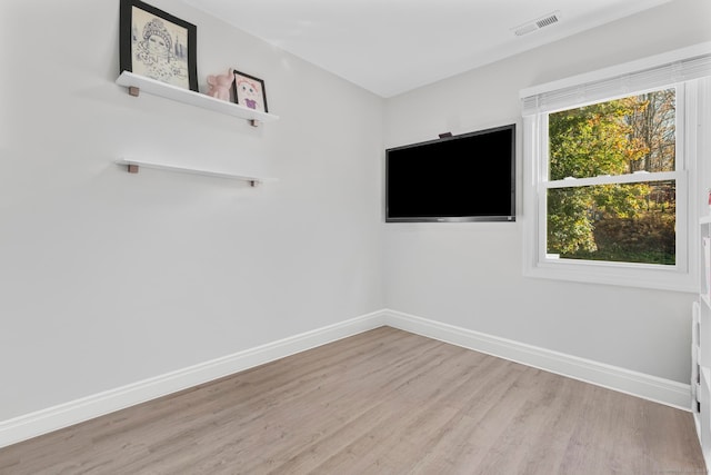 unfurnished room featuring light hardwood / wood-style flooring and a wealth of natural light