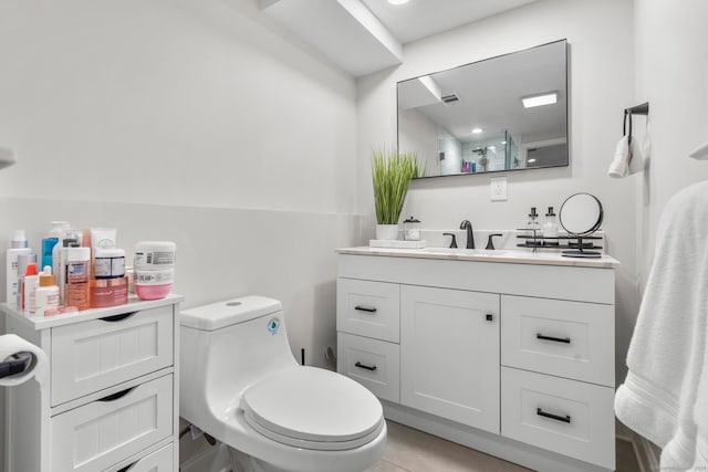 bathroom with vanity, toilet, and tile patterned floors