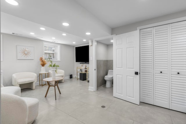 interior space featuring toilet and tile patterned flooring