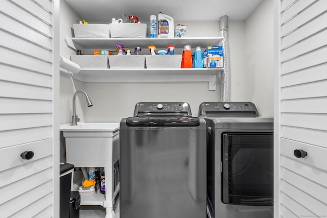 laundry area with independent washer and dryer and sink